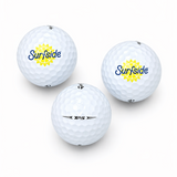 Three golf balls with 'Surfside' branding and TP5 branding on a white background