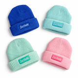Four beanies in blue, pink, and green with 'Surfside' logo patch on a white background