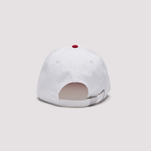 Back view of a white Stateside baseball cap featuring a red top button, stitched panel detailing, and an adjustable white strap with a silver-tone metal buckle.