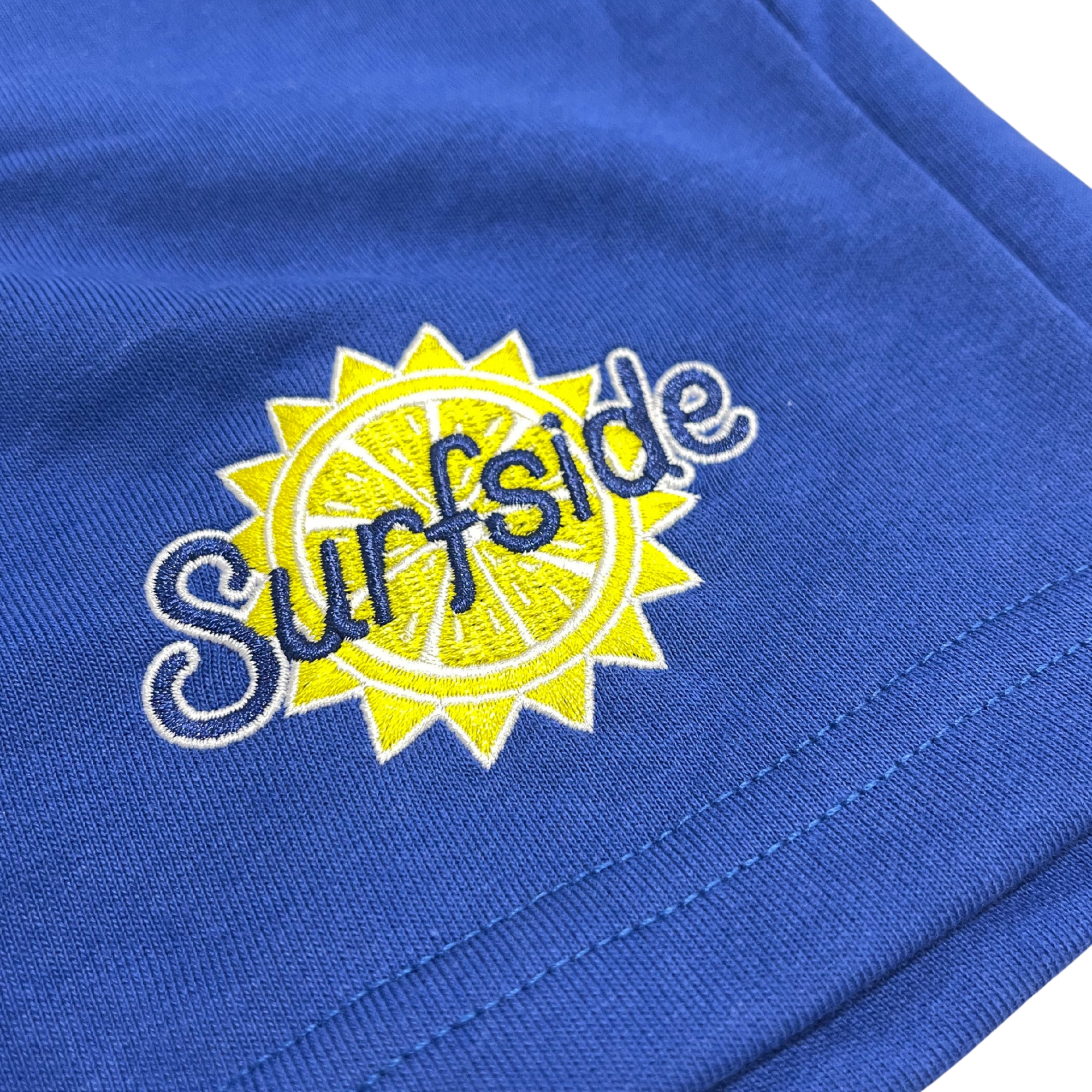 Close up of Surfside Logo placed on the blue sweat shorts 