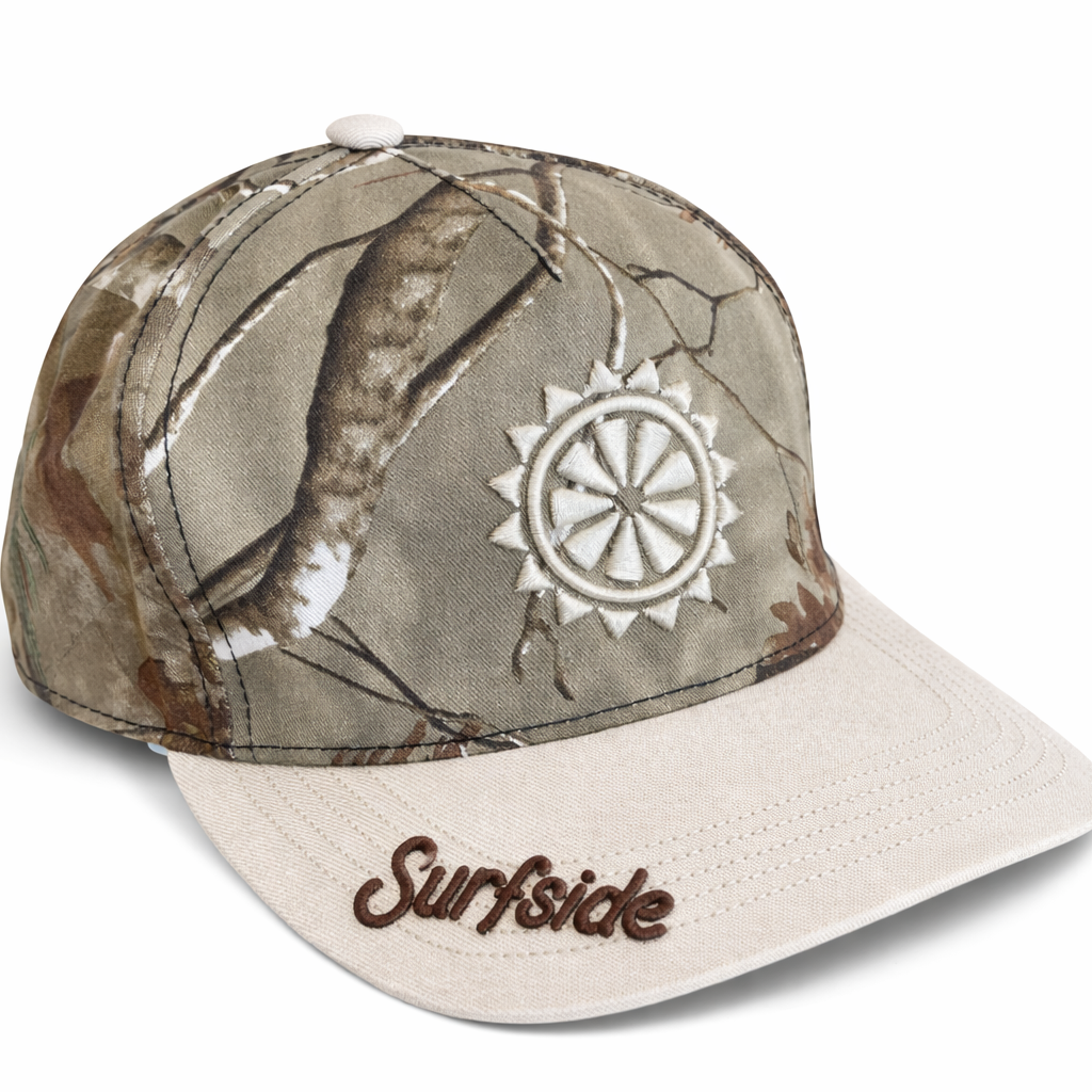 Side right view of the camo hat showcasing the embroidered Sun logo along with the Surfside logo