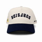Beige and navy cap with 'Surfside' text on a white background, Surfside logo on the right side and No Rivals text on the left