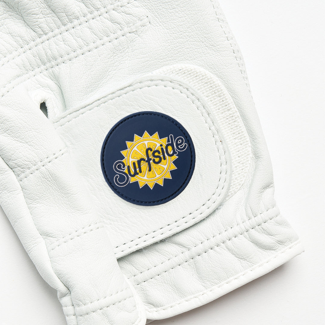White leather golf glove with a navy blue 'Surfside' logo on a white background
