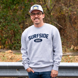 Person wearing a grey 'Surfside 2021' crewneck and white "Surfside Est. 2021" hat outdoors.
