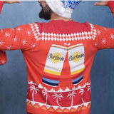 Person wearing a red Surfside can-themed red sweater with a blue and white holiday hat on a blue background