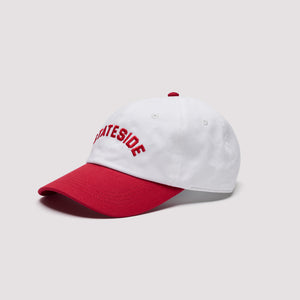 Side view of a white Stateside baseball cap featuring red embroidered lettering, a contrasting red curved brim, and a matching red top button.