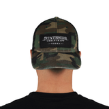 Person facing backwards showing the front of the Stateside Urban Craft Vodka Camo Hat with black patch logo