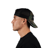 Side profile of a person wearing the Stateside Vodka Camo Trucker Hat