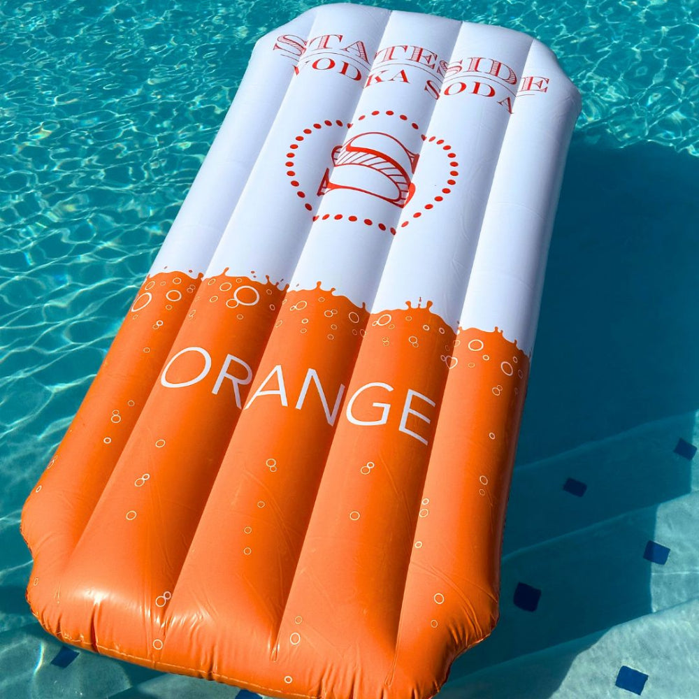 Inflatable pool float with 'Stateside Vodka Soda Orange' branding in a pool