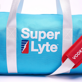 Close up of the Super Lyte Logo on the light blue Super Lyte duffel bag featuring white print and the Super Lyte bolt showing half of the red shoulder strap