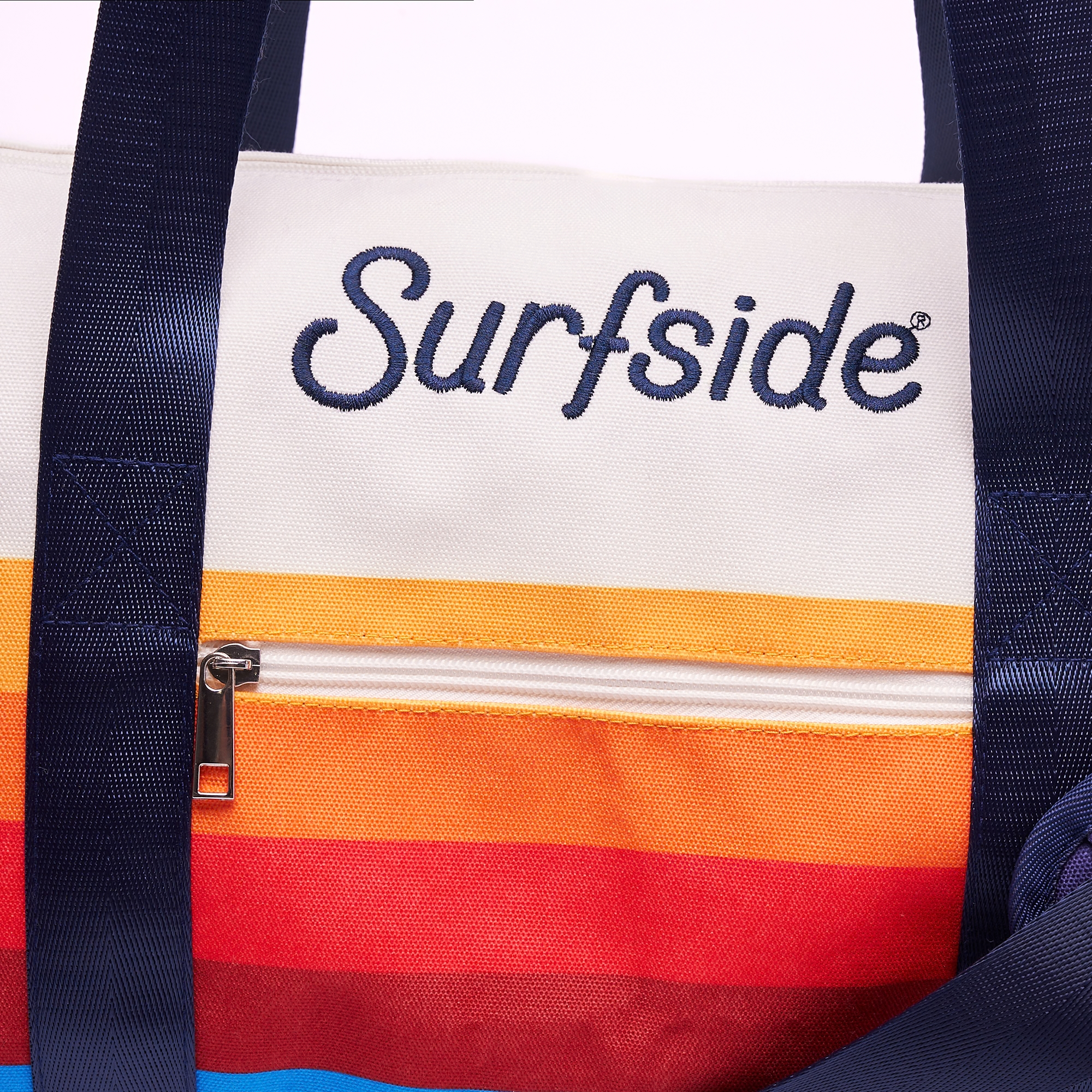 Close up of the Surfside duffel bag showing the embroidered Surfside logo and brand color details 