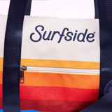 Close up of the Surfside duffel bag showing the embroidered Surfside logo and brand color details 