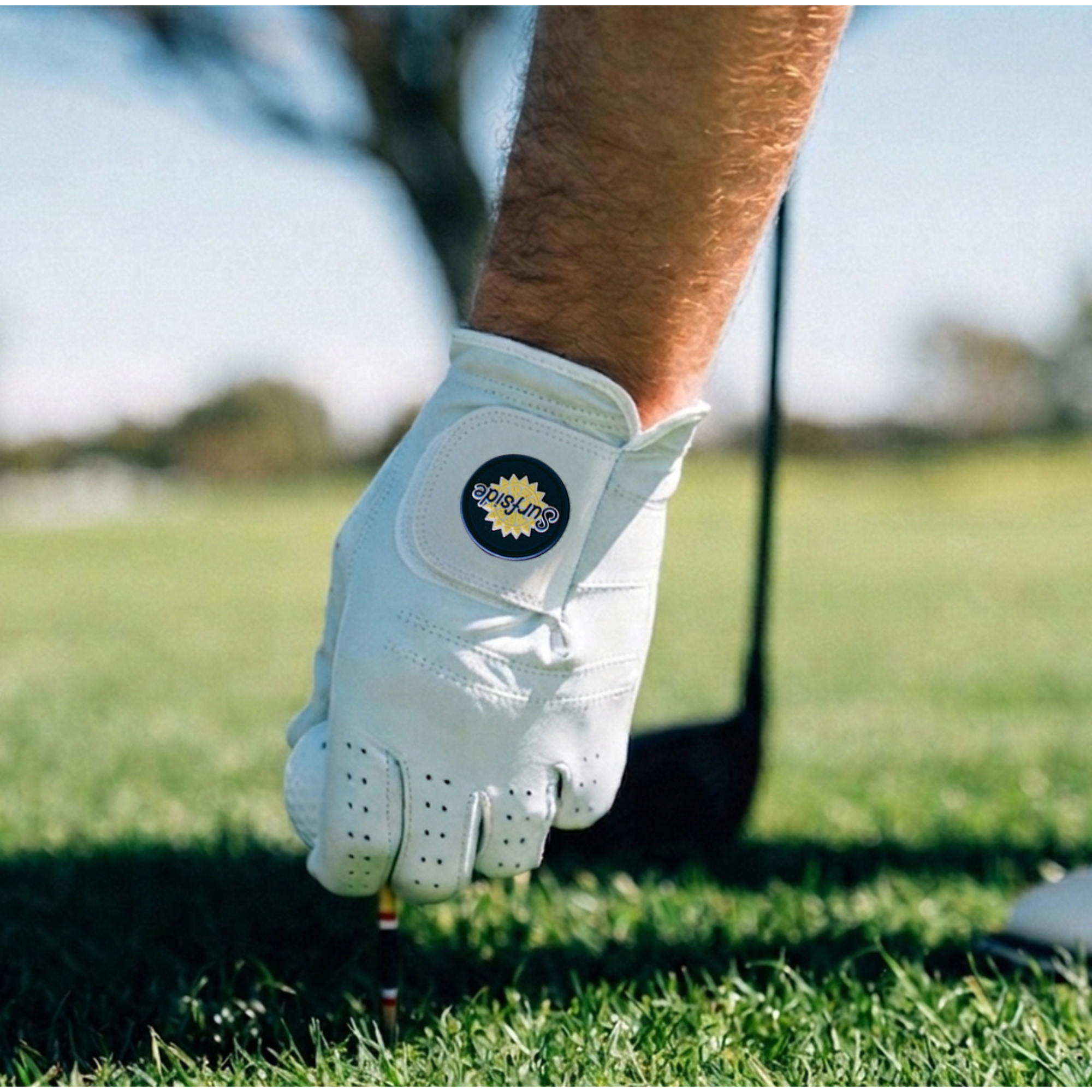 Surfside and Palm Golf collaboration golf glove on a golf course with a blurred background