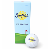 Surfside gold ball box and golf ball on a white background