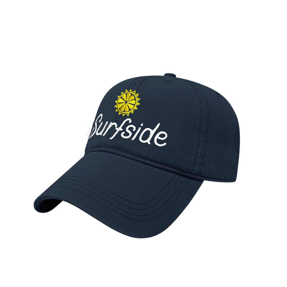 A navy blue baseball cap with 'Surfside' written on it and a small yellow graphic that appears to be a sun.