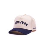 Beige and navy cap with "Surfside" upside down print and No Rivals print on the side laying on a white background