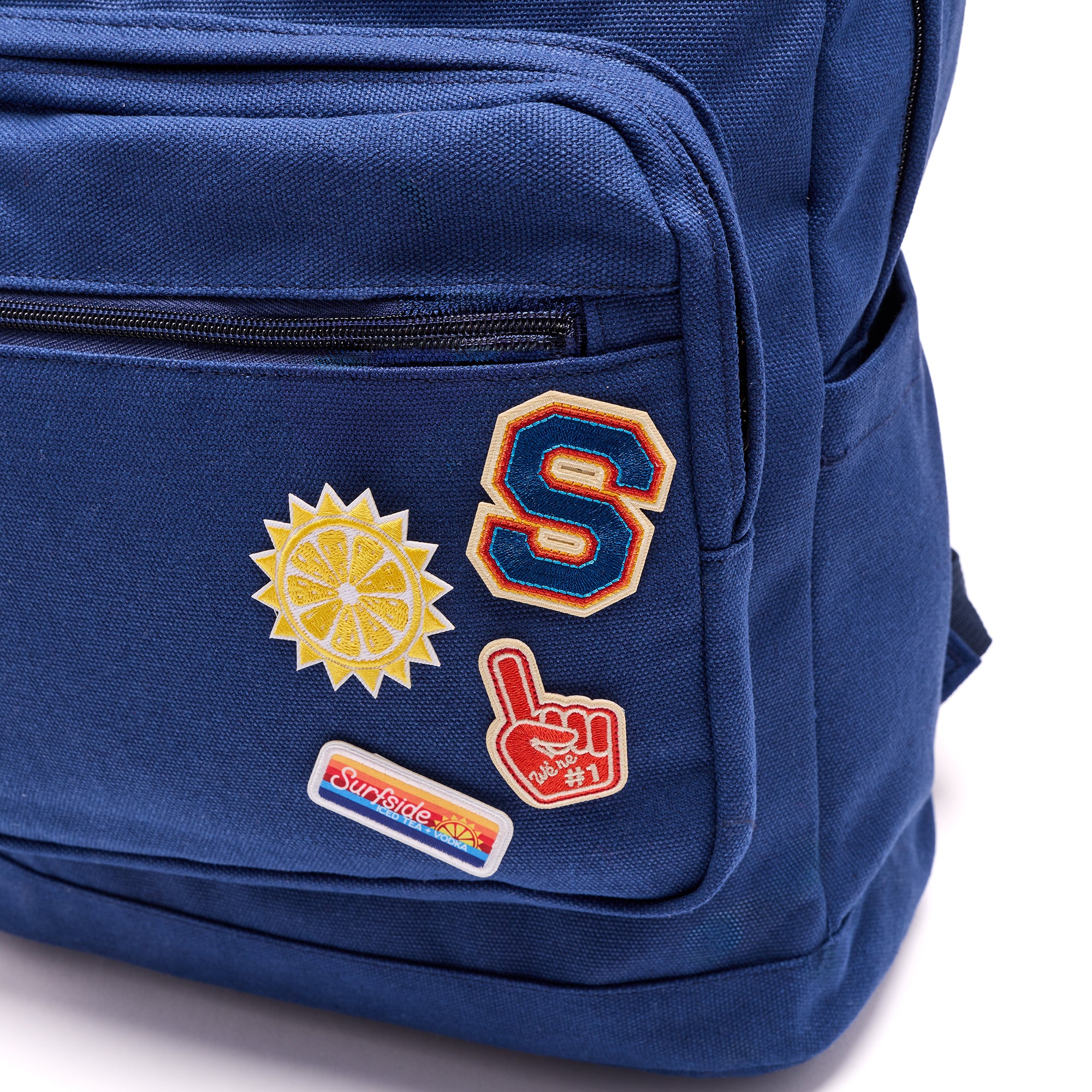 Surfside Patches with Tailgate theme shown on the corner of a blue on canvas backpack