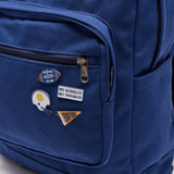4 Surfside themed Tailgate pins featured on a blue canvas backpack. the Pins use Surfside brand elements 
