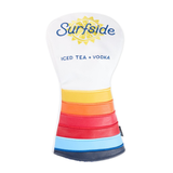 A Surfside golf club headcover featuring a white top section with a yellow sun graphic and blue 'Surfside' branding, and a lower body with horizontal stripes in yellow, orange, red, light blue, and dark blue.