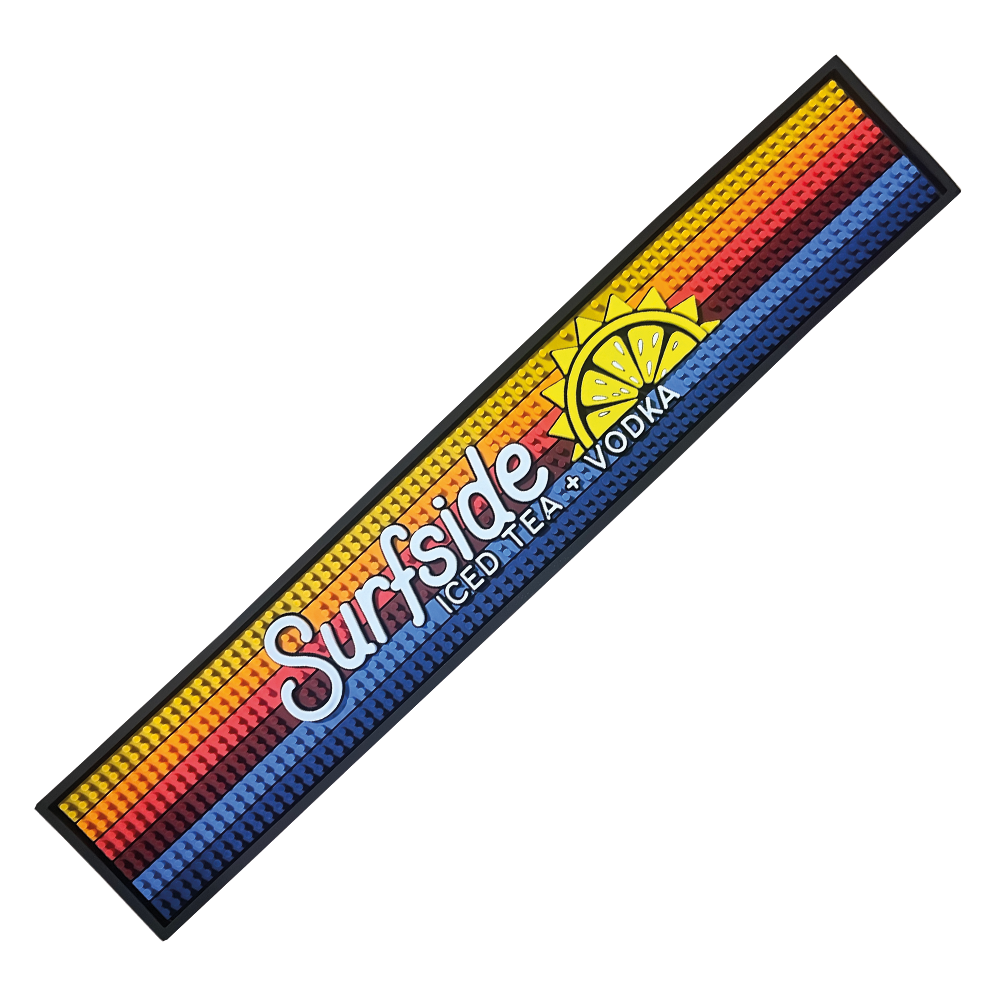 A long, colorful rail mat with the Surfside brand logo and a sun graphic in the center, predominantly featuring blue and yellow stripes with a red and orange gradient at one end.