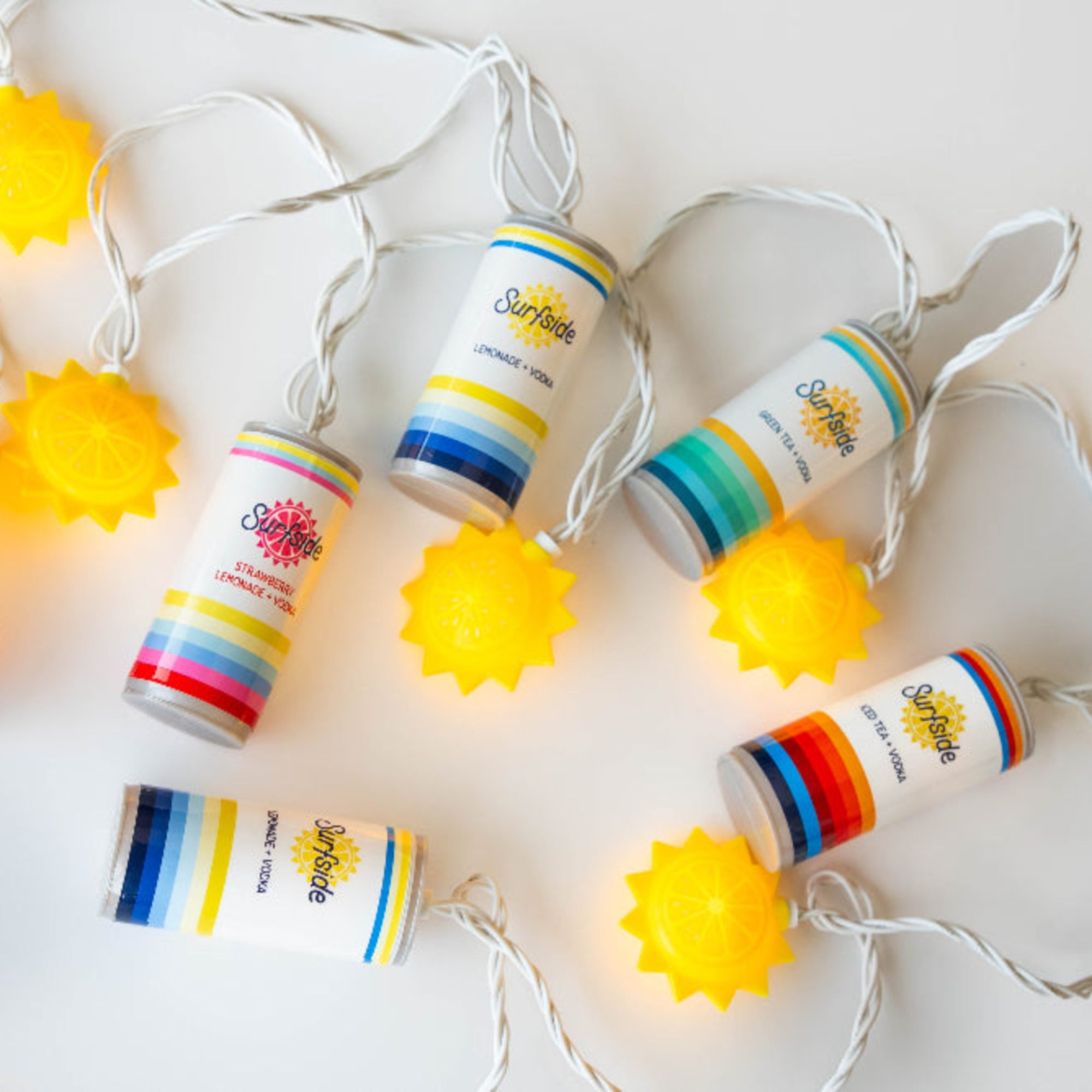 Surfside String lights with colorful Surfside cans and suns on a white background