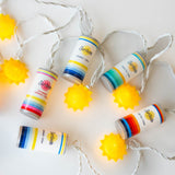 Surfside String lights with colorful Surfside cans and suns on a white background