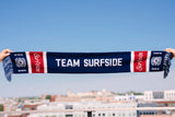 Team Surfside USA 250 Themed Soccer Scarf with the Surfside logo and the Surfside Sun logo with Fringe. This scarf is red, white and blue