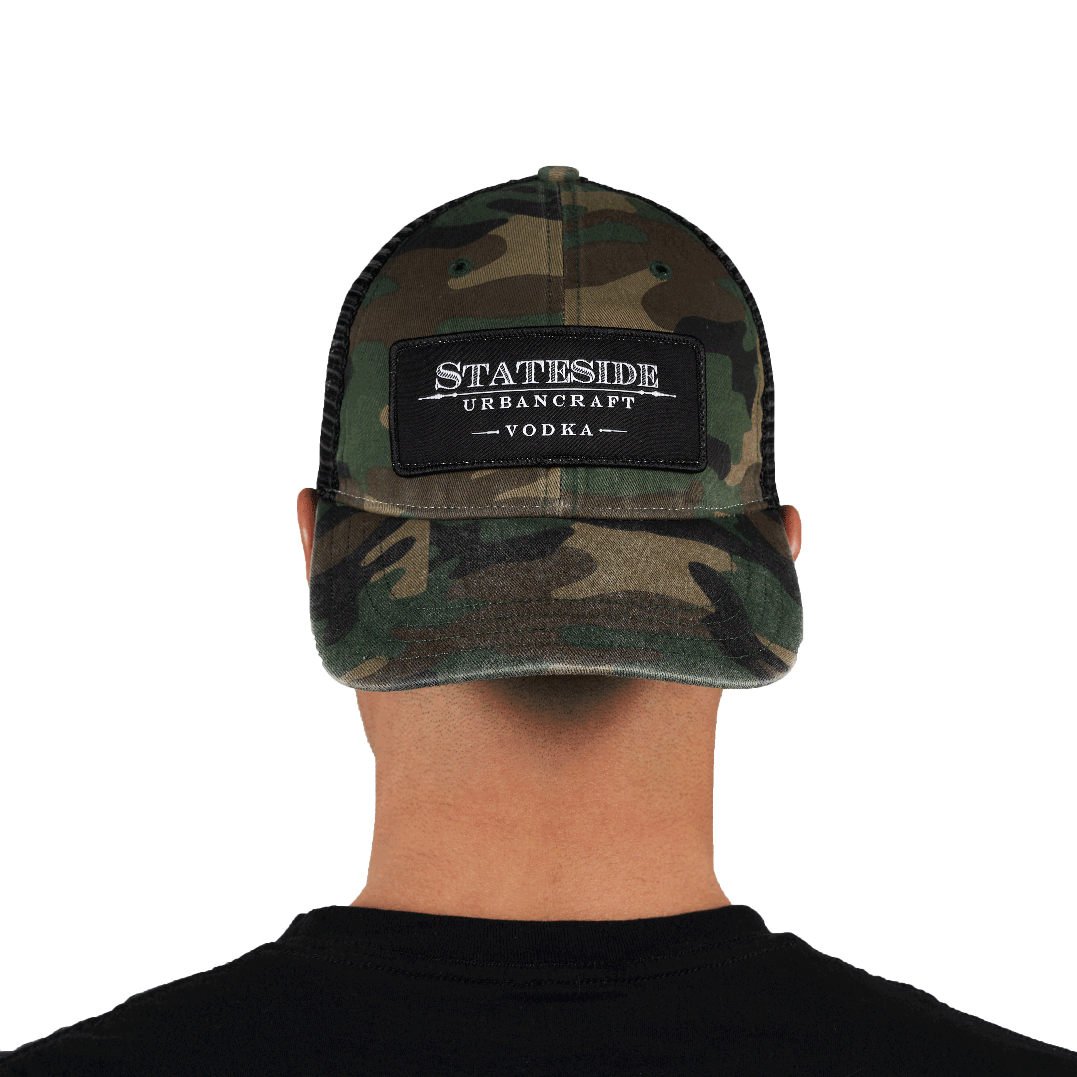 Person facing backwards showing the front of the Stateside Urban Craft Vodka Camo Hat with black patch logo